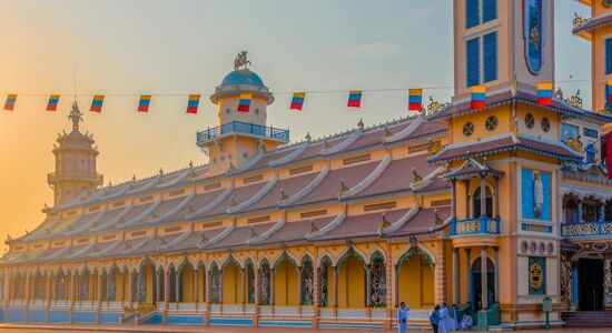 Cao Dai Temple’s vibrant architecture during a guided Cao Dai Tours experience with Legend Travel Group in Tay Ninh.